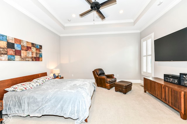 bedroom with ceiling fan, crown molding, light colored carpet, and a tray ceiling