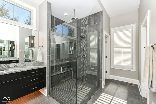 bathroom with vanity, baseboards, visible vents, a shower stall, and wood tiled floor