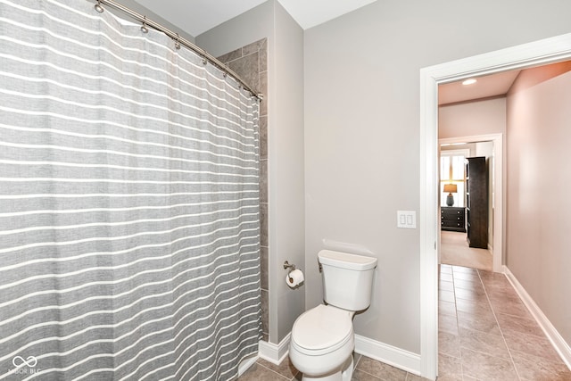 bathroom with toilet and tile patterned flooring