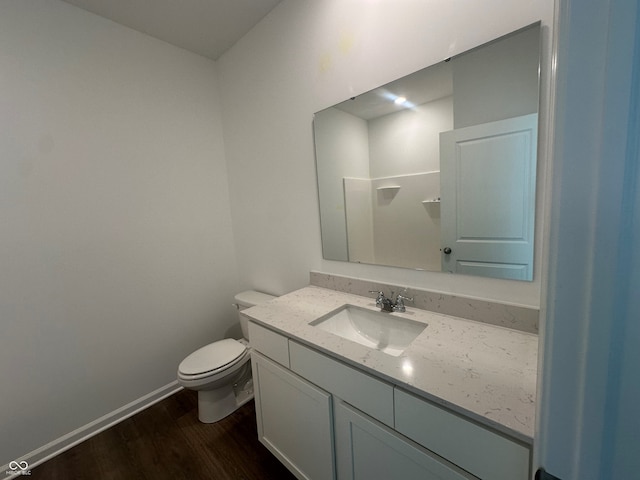 bathroom with vanity, wood-type flooring, and toilet