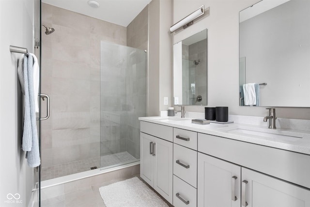 bathroom with tile patterned floors, vanity, and an enclosed shower