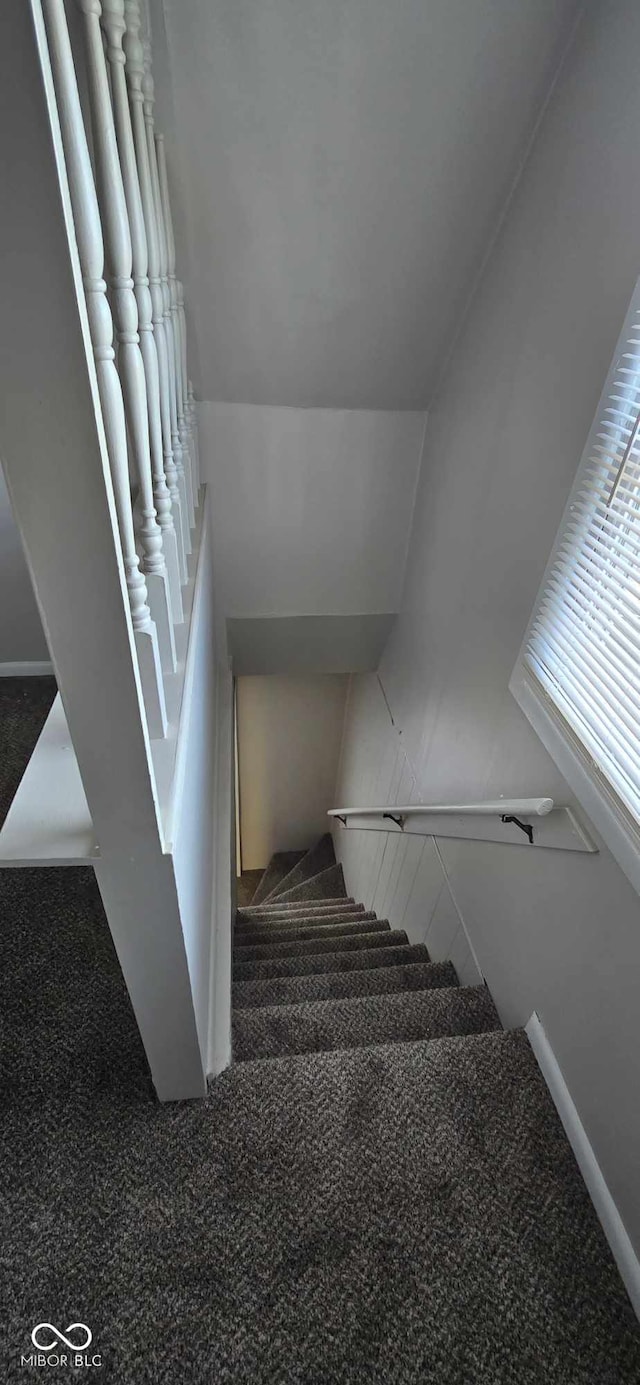 stairs with carpet and lofted ceiling