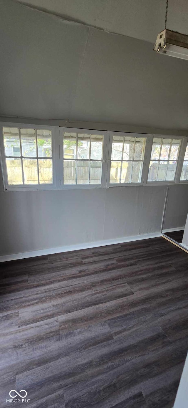 unfurnished room with dark hardwood / wood-style flooring