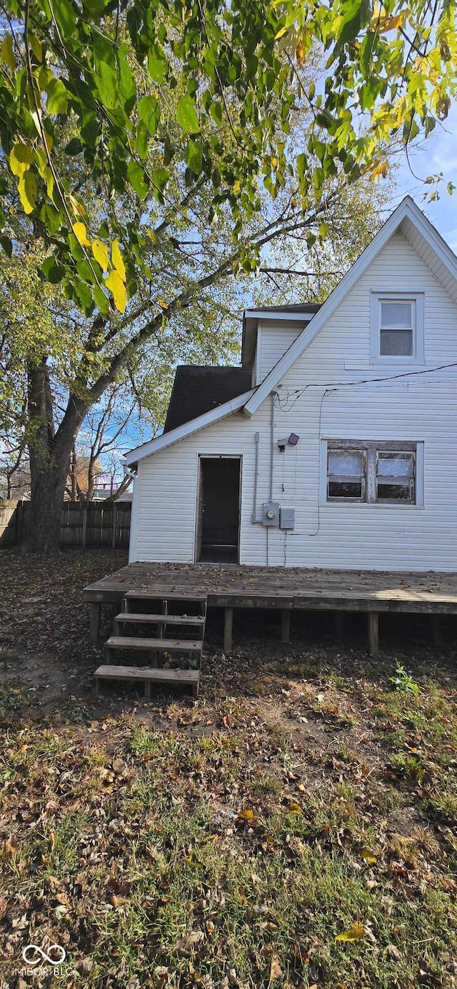 view of side of property featuring a wooden deck