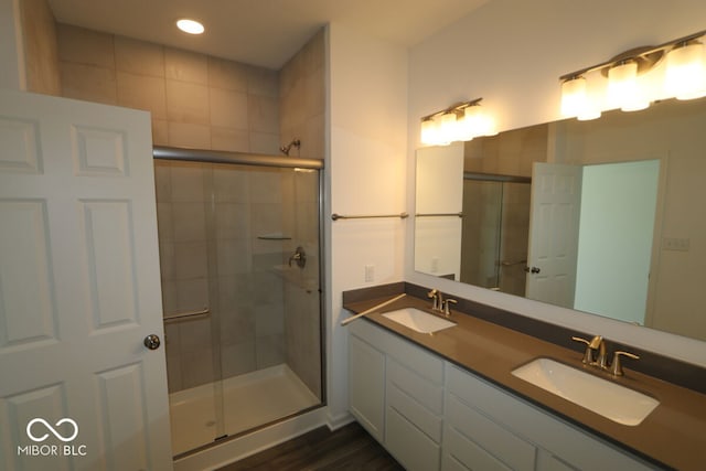 bathroom with vanity, hardwood / wood-style flooring, and an enclosed shower