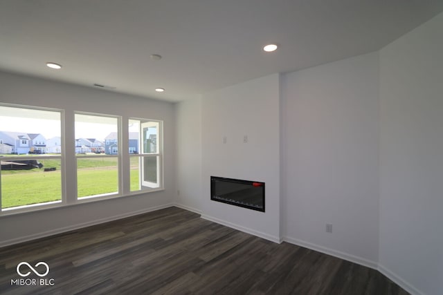 unfurnished living room with dark hardwood / wood-style flooring