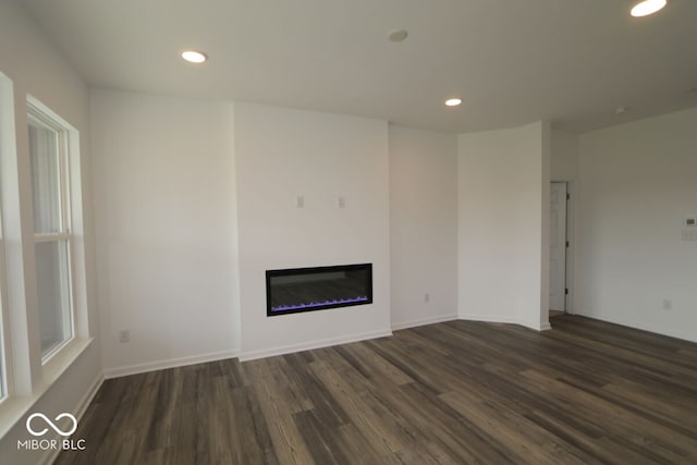 unfurnished living room featuring dark wood-type flooring