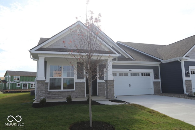 craftsman house featuring a garage and a front yard