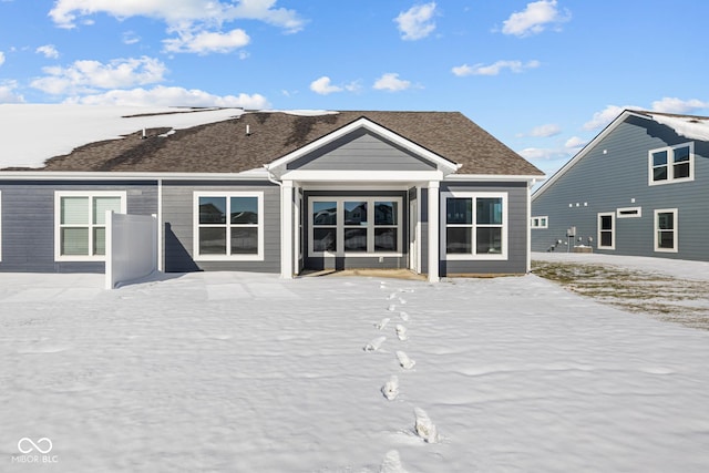 view of snow covered rear of property