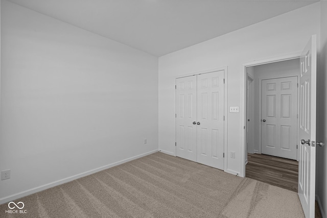 unfurnished bedroom with a closet and carpet flooring