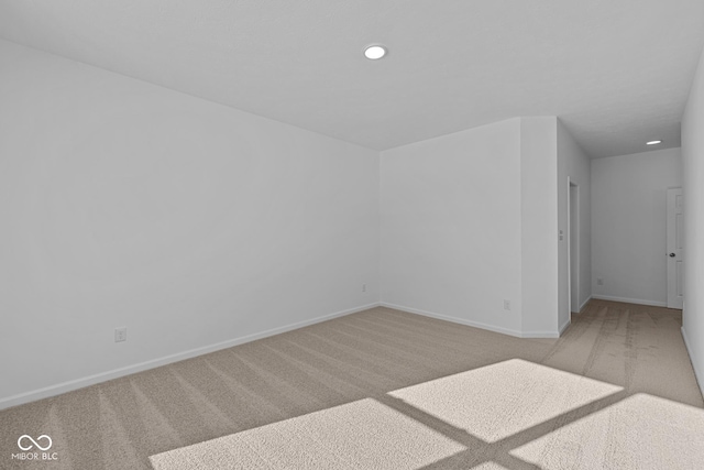 unfurnished room featuring light colored carpet