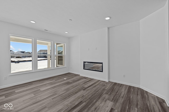 unfurnished living room featuring hardwood / wood-style floors