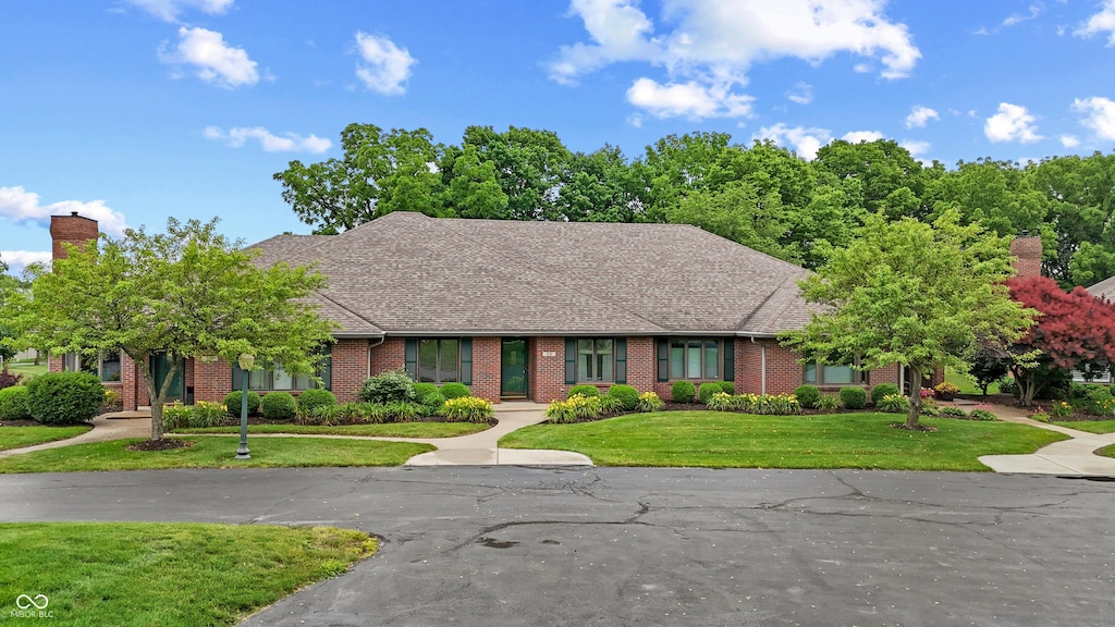 316 Northpointe Ct, Danville, IN 46122 - view of front of property with brick siding, a front lawn, and a chimney