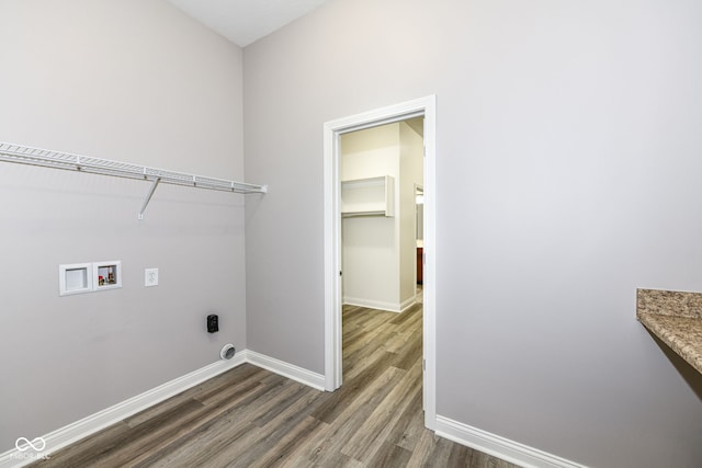 washroom with hookup for an electric dryer, dark wood-type flooring, and hookup for a washing machine