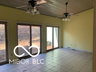 unfurnished room with ceiling fan and wooden ceiling