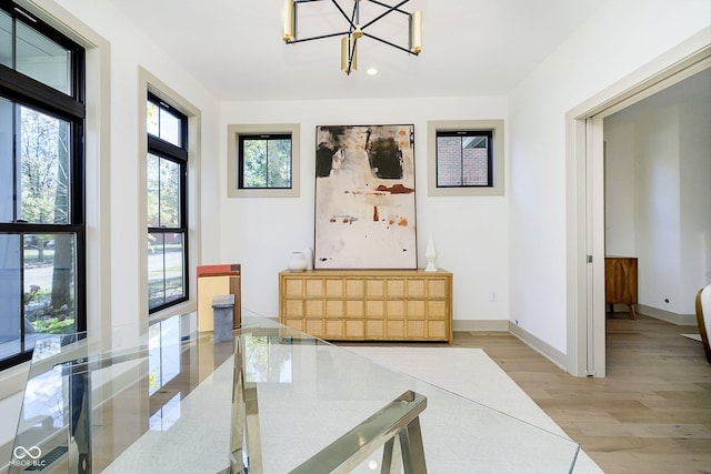 interior space featuring light hardwood / wood-style flooring and a chandelier