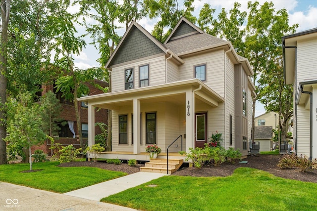 view of front of property with a porch, central AC unit, and a front yard