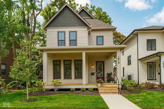 view of front of house with covered porch and a front yard