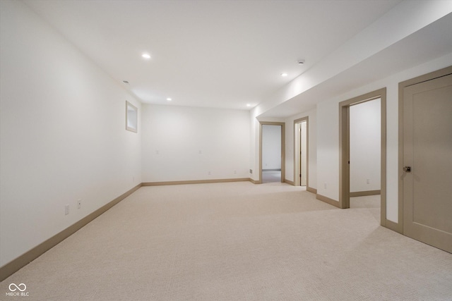 basement featuring light carpet