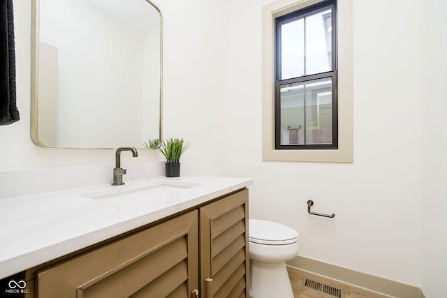 bathroom featuring toilet and vanity