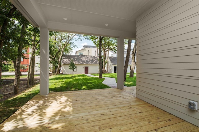 wooden terrace featuring a yard