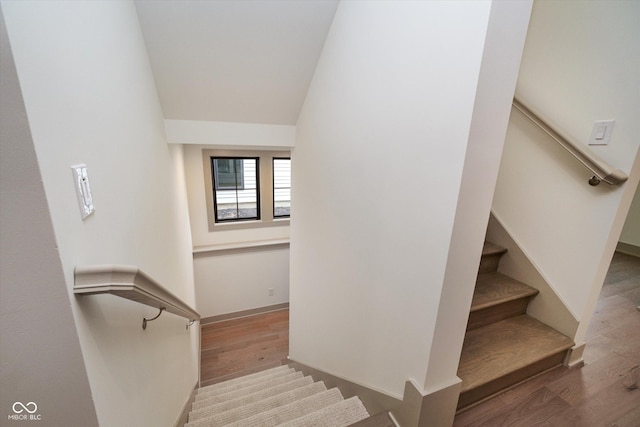 stairs featuring hardwood / wood-style floors