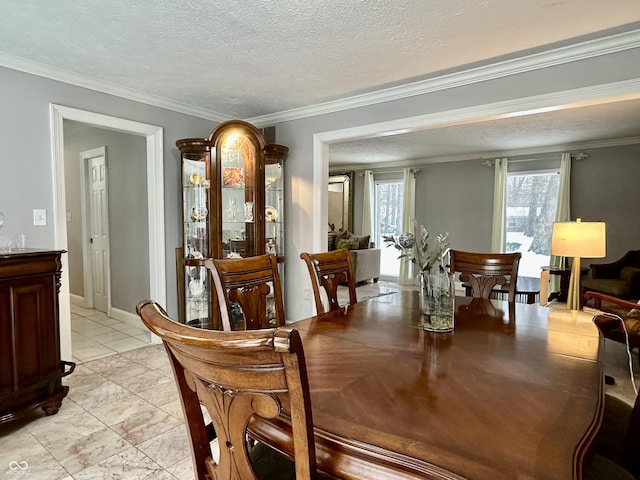 tiled dining space featuring a textured ceiling and crown molding