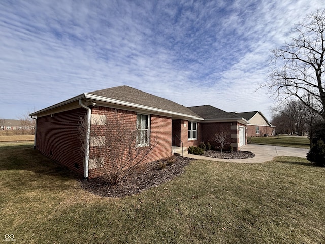 view of side of property with a yard and a garage