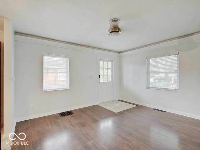 unfurnished room with hardwood / wood-style floors and ornamental molding