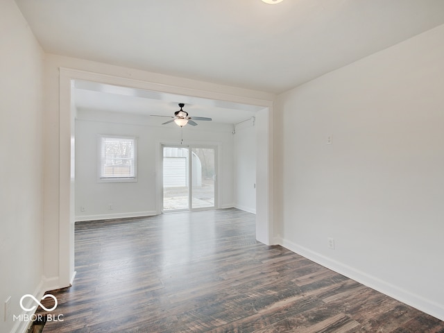 unfurnished room with ceiling fan and dark wood-type flooring