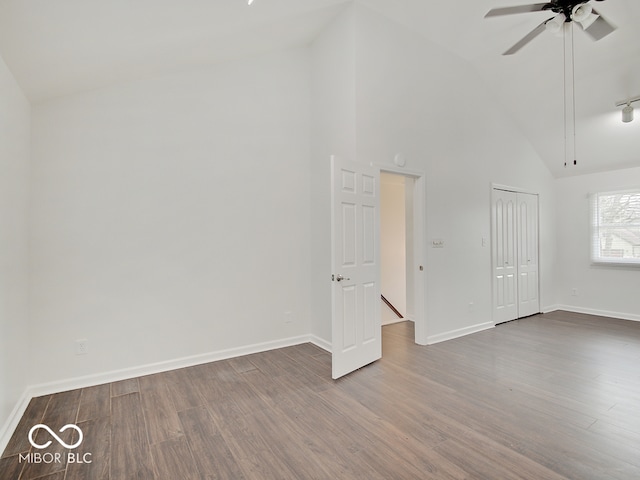 empty room with hardwood / wood-style floors, high vaulted ceiling, and ceiling fan