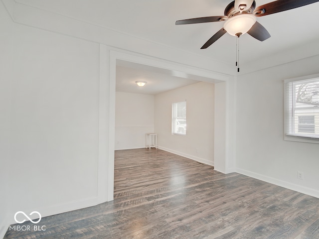 spare room with ceiling fan and dark hardwood / wood-style flooring