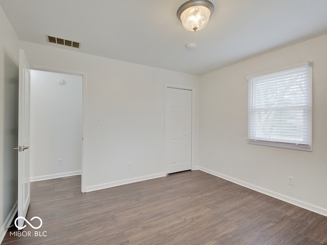 unfurnished room featuring dark hardwood / wood-style flooring