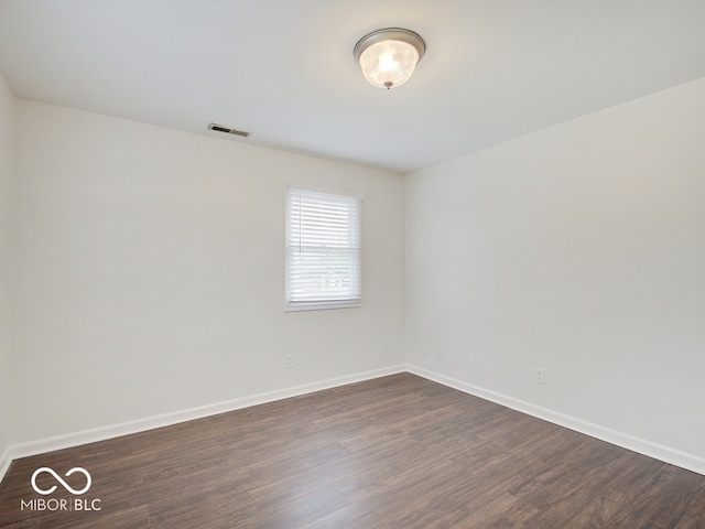 spare room with dark hardwood / wood-style floors