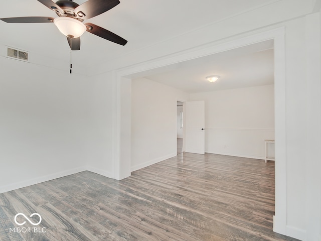 spare room with ceiling fan and wood-type flooring