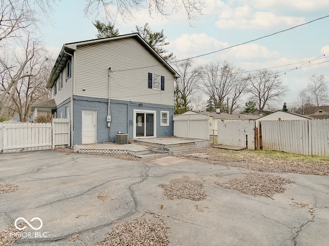 back of house with a patio area and central AC