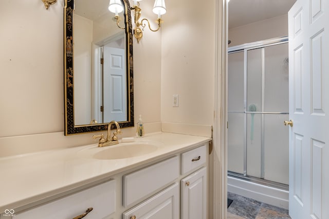 bathroom with vanity and a shower with door