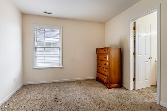 unfurnished bedroom with light colored carpet