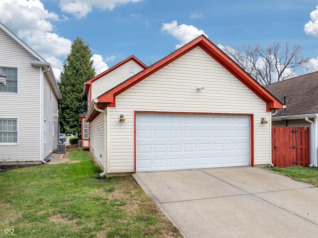 garage featuring cooling unit and a yard