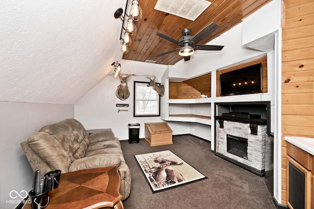 carpeted living room with a textured ceiling, ceiling fan, lofted ceiling, and a fireplace