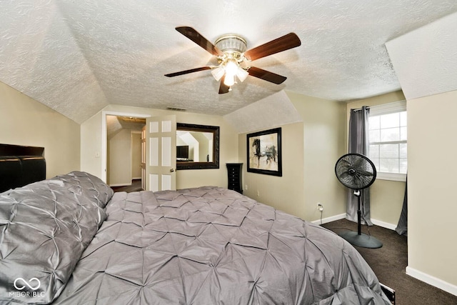 bedroom featuring ceiling fan, carpet floors, a textured ceiling, and vaulted ceiling