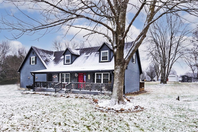 cape cod-style house featuring covered porch