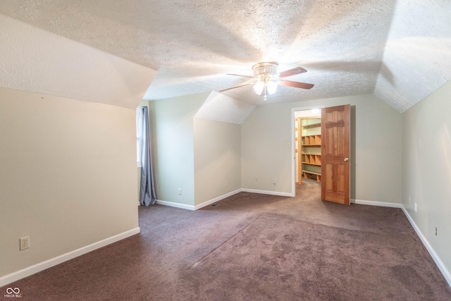 bonus room featuring ceiling fan, vaulted ceiling, carpet floors, and a textured ceiling