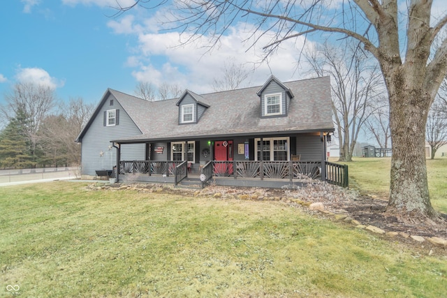 new england style home with a front yard and a porch