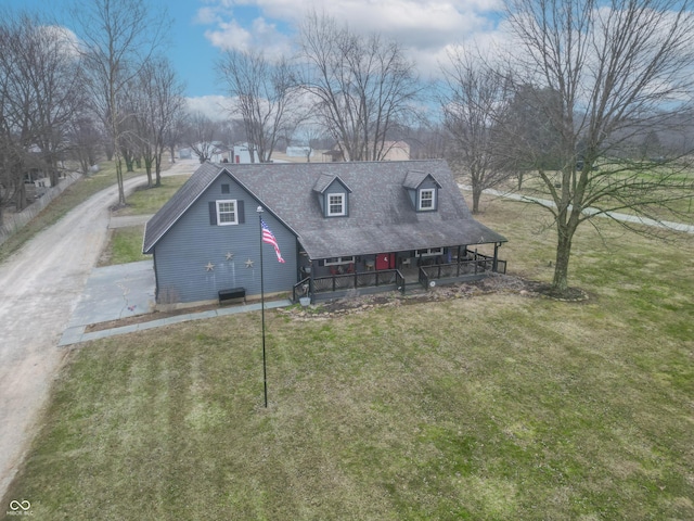 view of front of home featuring central air condition unit, a front lawn, and a porch