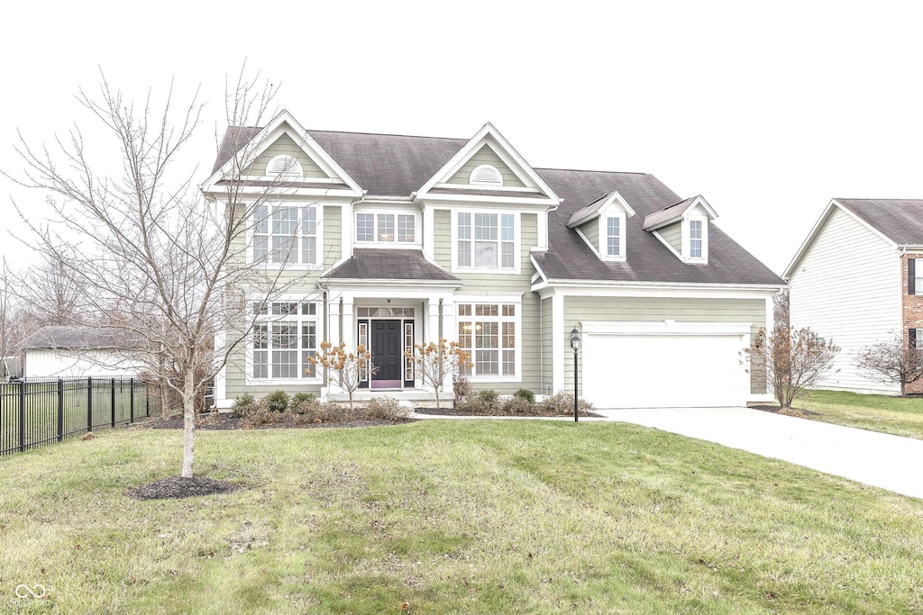 view of front of house with a garage and a front yard