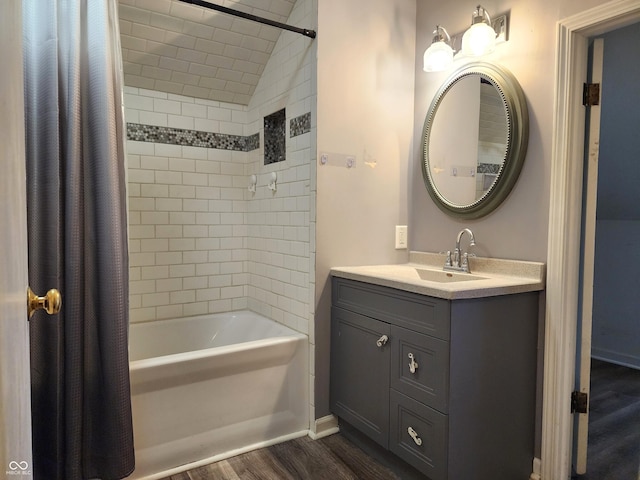 bathroom with hardwood / wood-style floors, shower / bath combo, and vanity