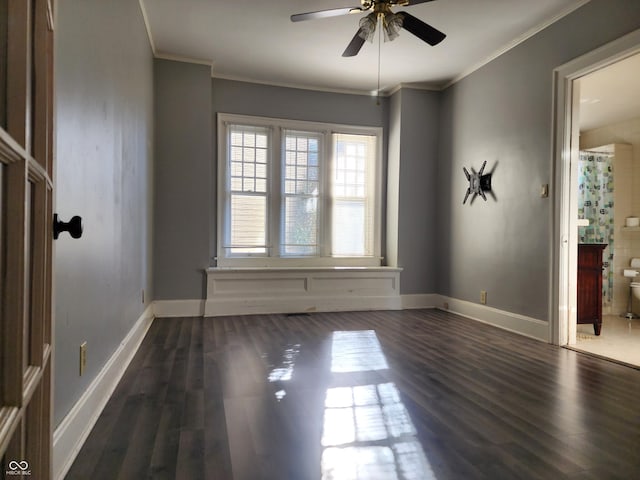 spare room featuring dark hardwood / wood-style flooring, ceiling fan, and crown molding