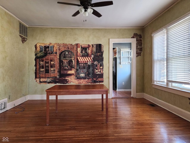 unfurnished dining area with wood-type flooring, plenty of natural light, crown molding, and ceiling fan