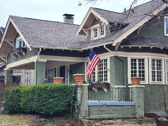 view of side of property with covered porch